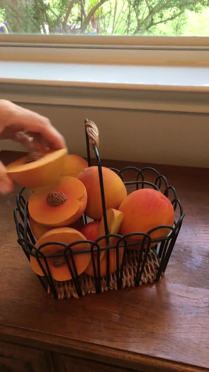 Wire basket of wooden peaches